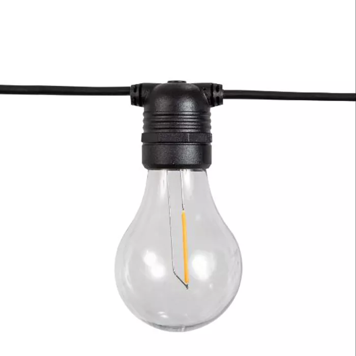 Darc — Une ampoule en verre transparent suspendue par un câble noir à l'aide d'un connecteur noir, prête à diffuser une lumière chaude pour éclairer u