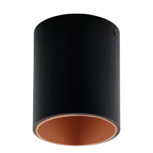 Darc — Un luminaire cylindrique noir avec une base intérieure orange, posé sur un fond clair, évoquant une ambiance lumineuse et chaleureuse.