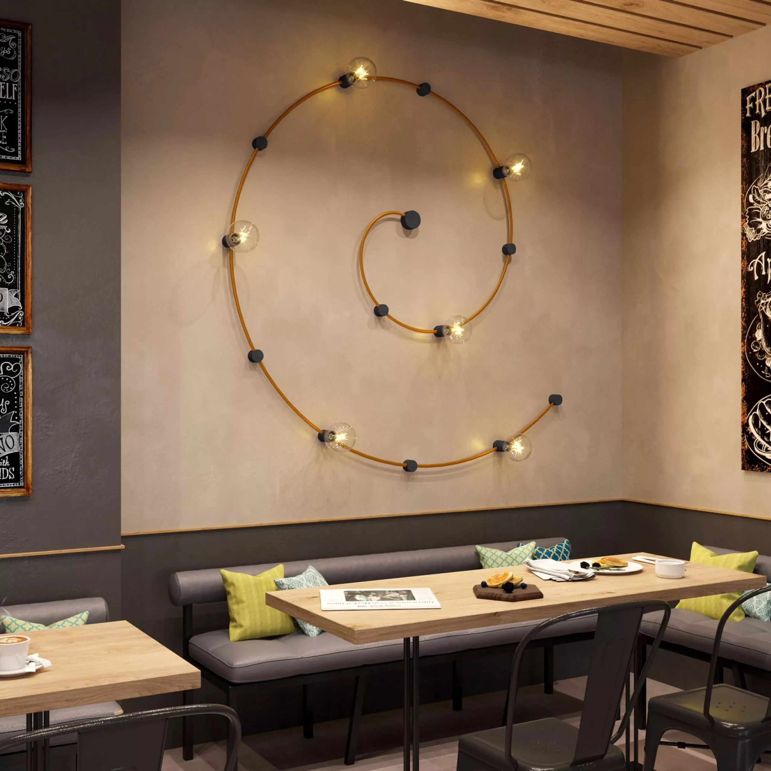 Darc — Une pièce avec une banquette en cuir gris dotée de coussins jaunes et verts, éclairée par un luminaire mural circulaire en forme de boucle avec