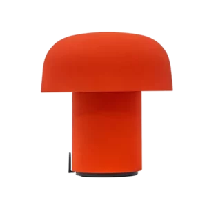 Darc — Lampe design en forme de champignon avec un abat-jour orange vif et une base transparente sur fond noir, évoquant une ambiance lumineuse et con