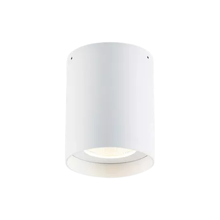 Darc — Applique murale de forme cylindrique en blanc, fixée au mur avec une lumière douce et diffuse émise depuis le bas, créant un éclairage ambiant