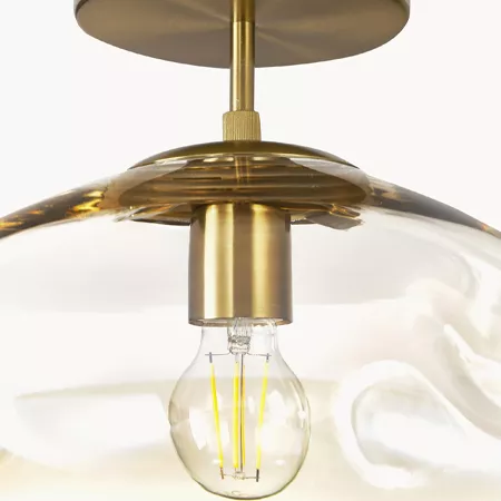 Darc — Une applique murale design en métal doré avec une ampoule LED à filament visible, suspendue sous un large disque circulaire.